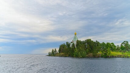The dome of the Nikolsky Skete among the vegetation on the island of Valaam.                       ...