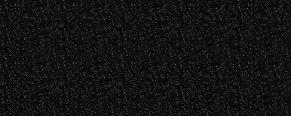 Fototapeta premium Dark, textured surface with a grainy appearance, resembling charcoal or a rough, dark material.