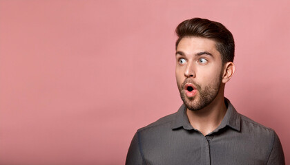 Obraz premium Surprise expression from a man with raised eyebrows and wide eyes against a pink background