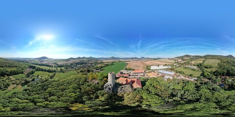 Aerial panorama of Skalka Castle in Vlastislav Bohemia showcasing its historical significance and scenic surroundings in the Czech countryside, a blend of culture and nature.