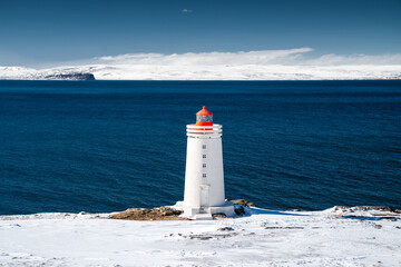 Lighthouse on Snowy Coastline