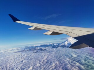 Fototapeta premium Airplane window view mountain and snow