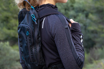 Beautiful Caucasian white girl with a sports backpack. Healthy lifestyle warming up outdoors