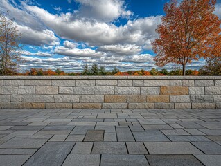 Fototapeta premium Stone Wall and Autumn Trees under a Cloudy Sky, Landscape, Autumn