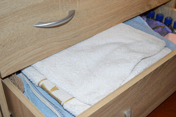 open drawer filled with clothes towels storage systems wardrobe organization or closet solutions...