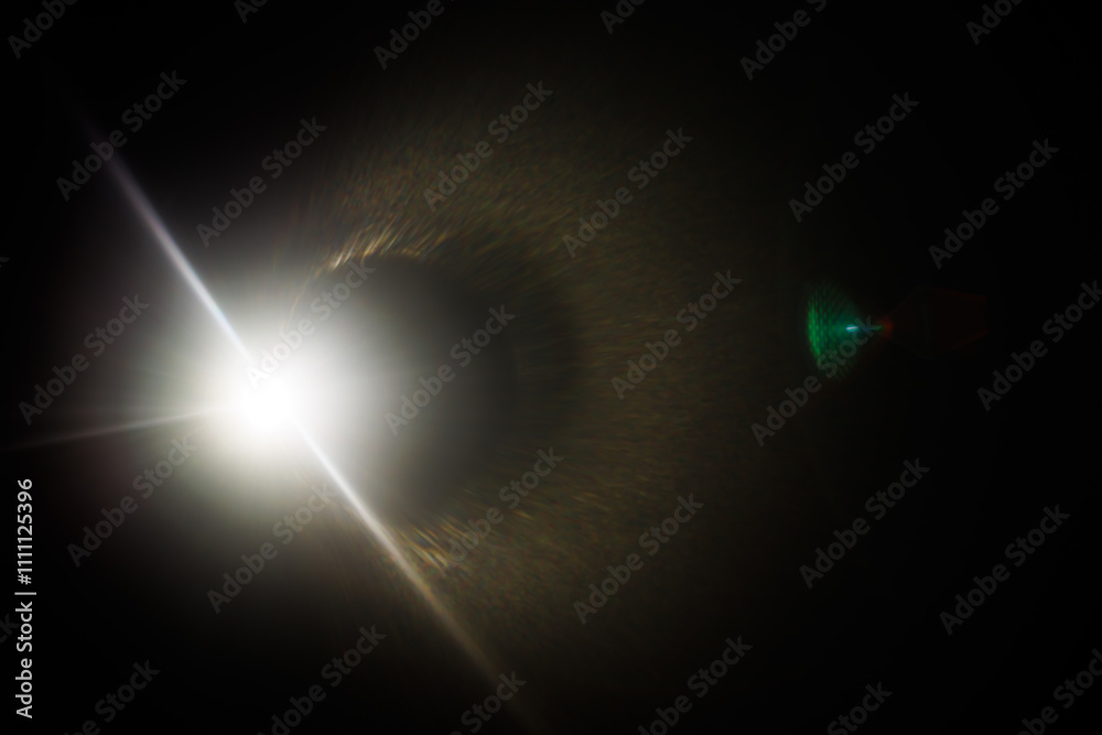 Aufkleber Easy to add lens flare effects for overlay designs or screen blending mode to make high-quality images. Abstract sun burst, digital flare, iridescent glare over black background.