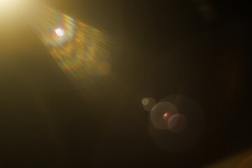 Easy to add lens flare effects for overlay designs or screen blending mode to make high-quality images. Abstract sun burst, digital flare, iridescent glare over black background.