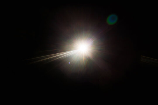 Easy to add lens flare effects for overlay designs or screen blending mode to make high-quality images. Abstract sun burst, digital flare, iridescent glare over black background. - Powered by Adobe