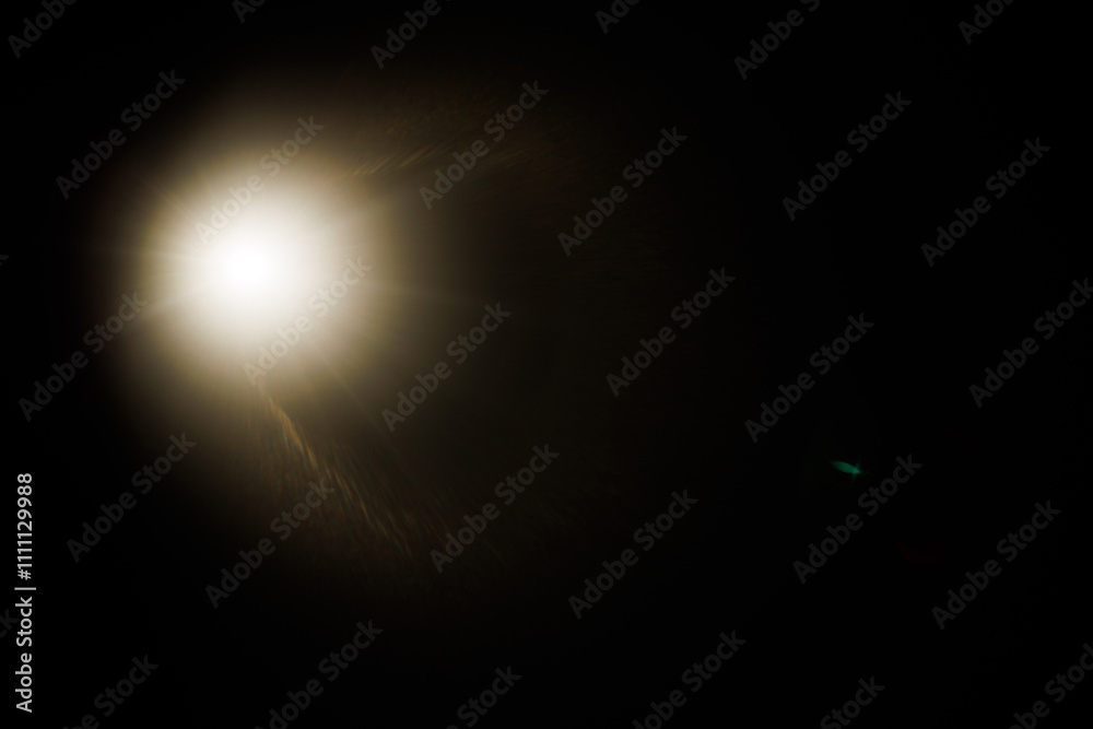 Poster Easy to add lens flare effects for overlay designs or screen blending mode to make high-quality images. Abstract sun burst, digital flare, iridescent glare over black background.