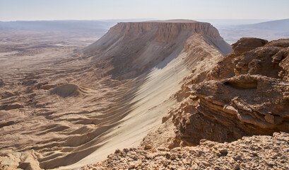 A path on the ridge of Mount Zin or Har Zin in Har Hahar nature reserve in the the Negev Desert. Unique landscape of the mount - a top like flat table. Tourist in a hiking trail. Active lifestyle.