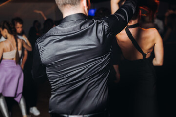 Couples dancing traditional latin argentinian dance milonga in the ballroom, tango salsa bachata...