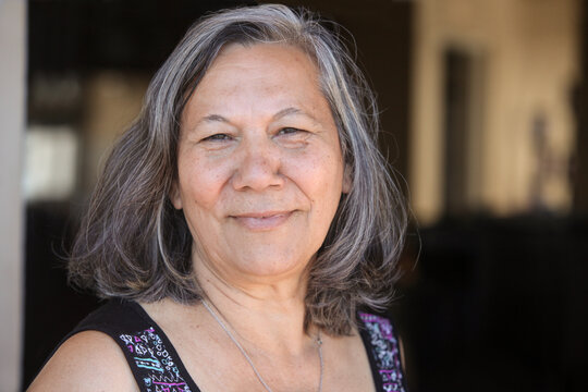 closeup portrait of  cheerful guarani senior latina  woman  