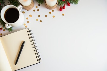 Cozy Workspace Setup with Notebook, Pen, Hot Coffee, and Festive Decorations for New Year Resolutions and Winter Inspiration
