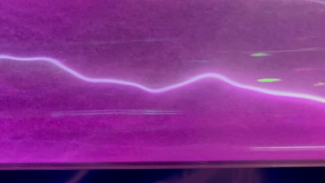 Pink gas electric discharge in transparent glass tube