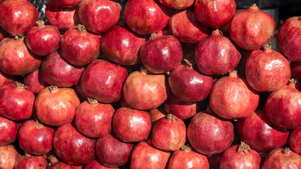 Red pomegranate fruits at a street market.