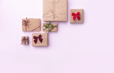 Festive Christmas Gifts Beautifully Wrapped Presents with Elegant Bows on a Soft Pink Background