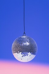 silver discoball suspended on a vibrant blue background