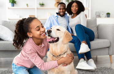 Adopt An Animal. Closeup portrait of cheerful African American girl embracing her labrador from...