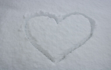 A big heart painted on fluffy snow. The concept of love, Valentine's Day, March 8th