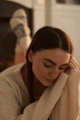 Fototapeta premium Woman in warm sweater resting at home