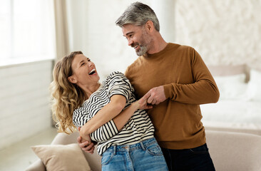 Joyful Couple Dancing Having Fun At Home. Loving Husband And Wife Having Date Hugging And Laughing...