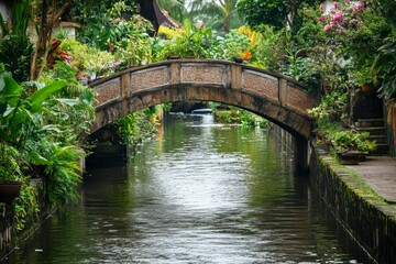 Naklejka premium Stone arch bridge spans lush, green waterway.