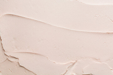 Top view of orange buttercream for decorating cake, silky smooth peach color american buttercream on a marble surface, overhead view of smooth light orange buttercream