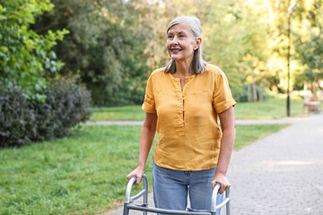 Senior woman with walking frame in park