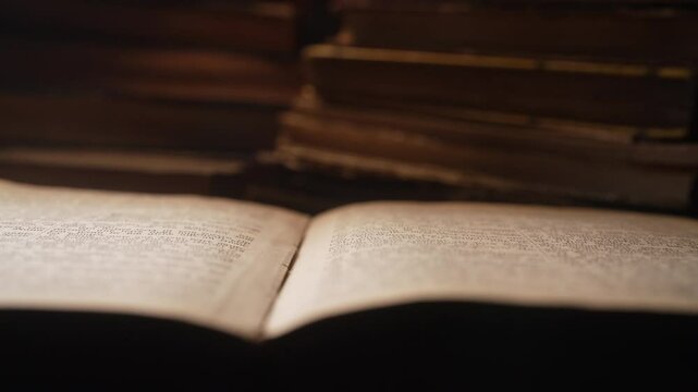 Opened saved old paper book with ancient writings. Religious literature, archival manuscripts, rare collection tomes, artifacts. 