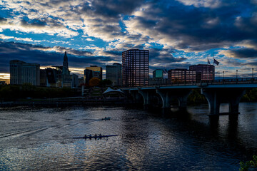 Fototapeta premium 10/19/22 - HARTFORD CT., USA - skyline view of Hartford CT on Connecticut River with lights coming on