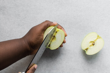 Top view of diced green apples on a marble countertop, overhead view of chopped apples on a white background