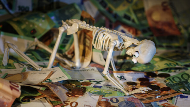 The concept of the photo is that wealth is evil, a man is on his knees praying for money.