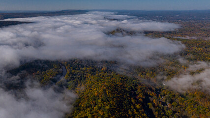 Obraz premium 10/15/22 DELEWARE RIVER GAP, PA, USA - aerial view of puffy clouds over forested area of Delaware River Gap, PA.