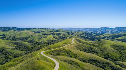 Lush green hills and winding roads aerial photography of natural landscape beauty