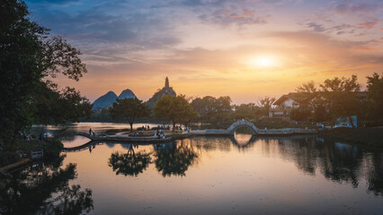 Tranquil Sunset Over a Scenic Lake with Green Surroundings