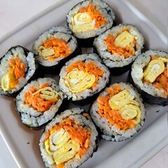 Delicious kimbap rolls filled with fresh vegetables, seasoned rice, and savory proteins, all wrapped in crisp seaweed. A perfect combination of flavor and texture in every bite.
