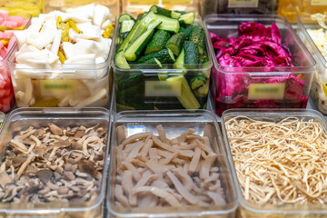 Colorful Assortment of Pickled Vegetables in Display Containers