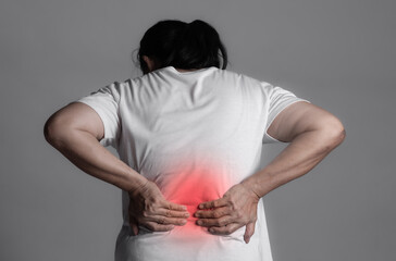 Elderly woman feeling back pain. Red highlight