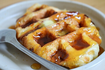 Close up of croffle or croissant waffle with mapple butter on plate