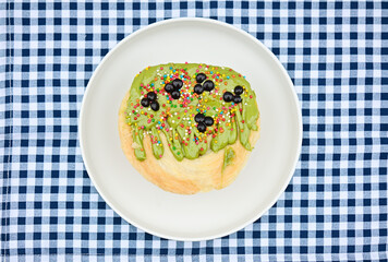 Top view of cromboloni on the plate with matcha topping isolated on the blue napkin. Crunchy and soft in the same time. 