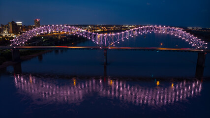 Fototapeta premium JULY 6, 2023 - MEMPHIS, TN, USA - Hernando De Soto Bridge LIGHT SHOW - Memphis, Tennessee over Mississippi River at night