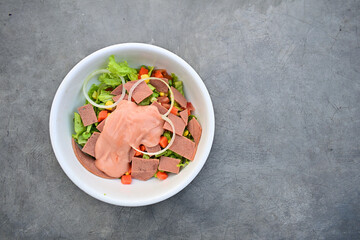 Top view of salad on the white bowl. Isolated on the grey background. Copy space.