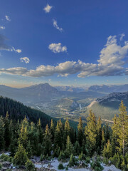 Fototapeta premium Majestic Mountain Valley with Lush Forests and a Clear Blue Sky