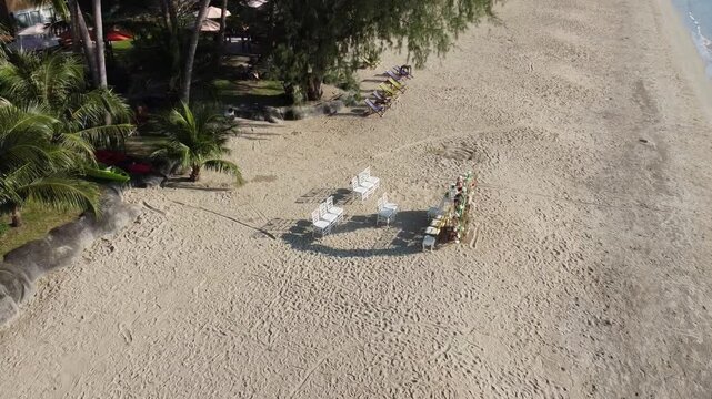 Topview setup decoration wedding avenue with white theme chairs on the beach.