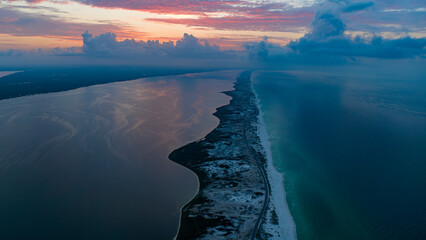 Naklejka premium JULY 13, 2023, PENSACOLA, FL., USA - aerial view of sunrise on Pensacola National Seashore National Park on Gulf of Mexico outside of Pensacola