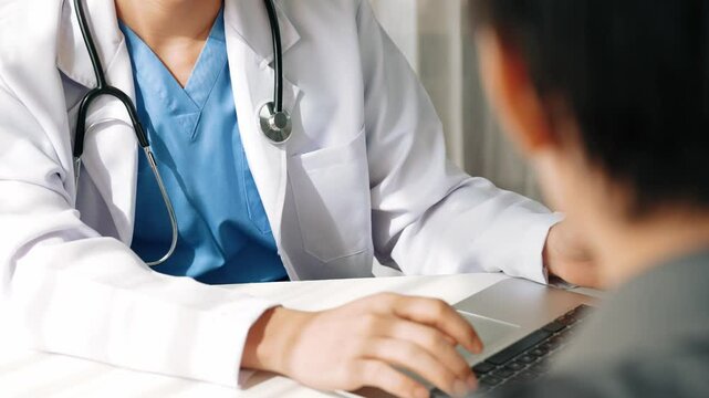 Doctor show laptop, display medical report or diagnostic result of patient health and curing way on doctor's appointment in hospital. Medical consultation and healthcare treatment. Slow motion. Rigid.