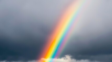A vibrant rainbow arcs across dark storm clouds, creating a stunning contrast of colors against the gloomy sky.