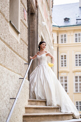 Fototapeta premium A sensual bride in white wedding dress at a dream wedding. The bride looked beautiful on wedding day. A beauty bride, perfect wedding. Elegance young bride. The brides beauty.