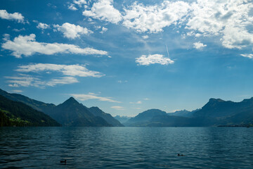 Blue nature background. Blue lake with blue sky near blue mountain.