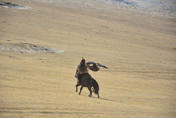 The Eagle Hunter taking his golden eagle to the mountain for hunting
